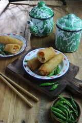 croquettes on a tin plate with two metal mugs