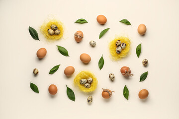 Composition with Easter eggs, green leaves and nests on white background