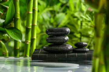 Fototapeta na wymiar Stack of spa stones in green garden
