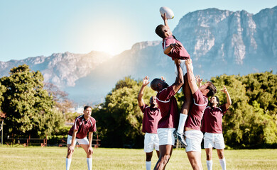 Team, ball or rugby men lifting a man together in training, exercise or workout match on sports field. Jumping in air, line out or powerful group in competitive game with physical fitness or effort