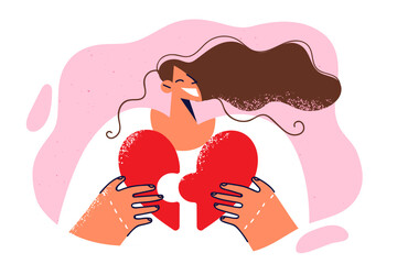 Happy girl holding heart puzzle and smiling broadly pimping loving people or arranging romantic date