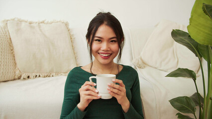 Portrait Of A Young Woman Drinking Coffee Or Tea At Home.