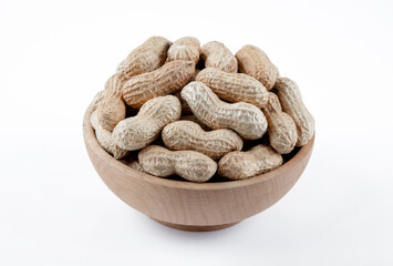 Bowl full of shelled peanuts on white background