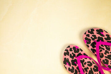 Summer concept. Beach and flip flops on yellow and sand color background. Flat lay. Minimal style....