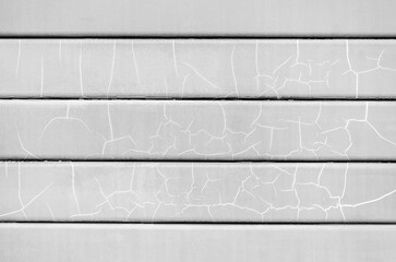 Texture of gray painted planks with cracks in paint. Old wall texture, horizontal panels. Background