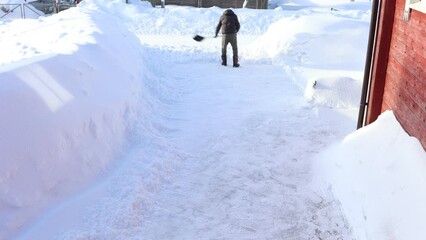 Clearing local area from snow in Finnish village, timelapse.