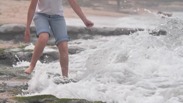 Mature woman being splashed by a wave