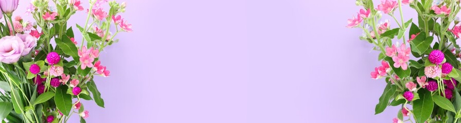 Fototapeta premium Top view image of pink and purple flowers composition over pastel background