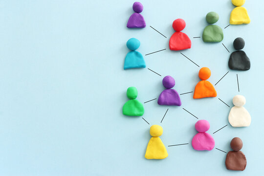 Colorful figures connected over blue background, concept of human resources and collaboration