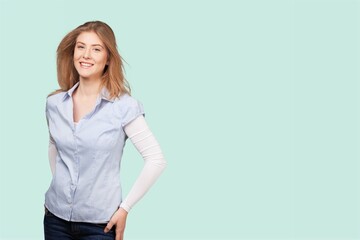 Smiling young woman posing on color background