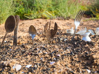 cutlery in the sandy soil
