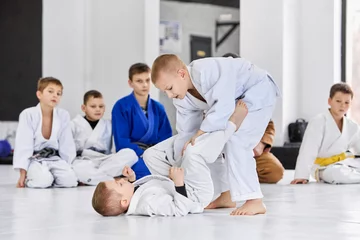 Dekokissen Little boys, children in white kimono training judo, jiu-jitsu indoors. Professional sports club for kids. Concept of martial arts, combat sport, sport education, childhood, hobby © master1305