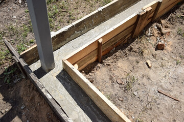 Wooden formwork concrete strip foundation for a veranda in a house.