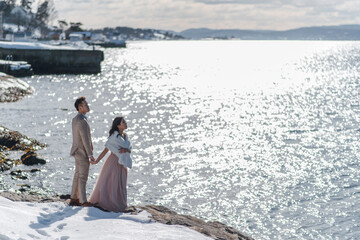Wedding ceremony of elegant bride and groom at big blue lake background