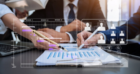 Businessmen team or financial data analysts working with tablets and laptop computers and data graphs together. Plan to analyzing projects in the office.