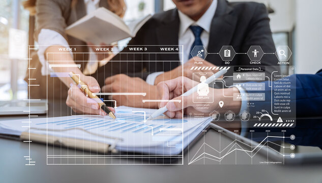 Businessmen team or financial data analysts working with tablets and laptop computers and data graphs together. Plan to analyzing projects in the office. - Powered by Adobe