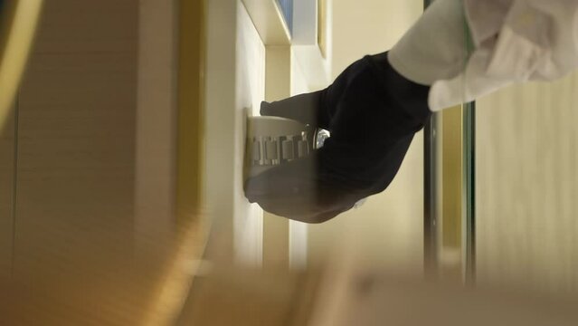 VERTICAL Salesperson hands reaching in to store display taking Piaget wristwatch out with price tag