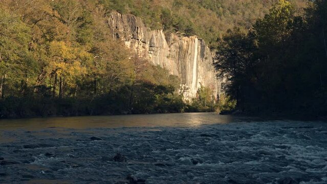Buffalo National River in Arkansas with mountain cliff face and colorful forest