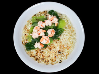 Noodle Soup with Shrimps and vegetable in white bowl isolated on black background. Traditional asian noodle soup.