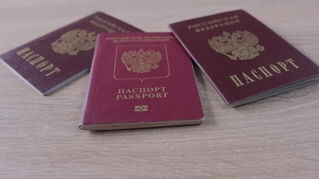 foreign International biometric passports, passport of citizen of Russian Federation with red cover on light background, stamp. Stop illegal migration concept, Prohibition and suspension of visas