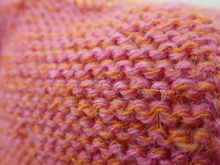 knitting from an orange and pink wool