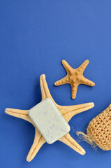 a bar of soap and a washcloth for spa on a blue background, copy space