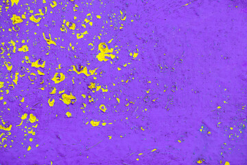 Old violet painted metal surface, with an abstract and expressive yellow pattern. Texture for the background