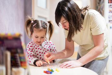 Fototapeta premium Mother and daughter decorating art with glitter decor.