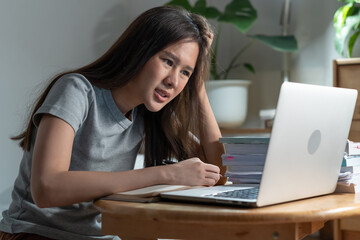 Stress College student studying at home via internet computer at night