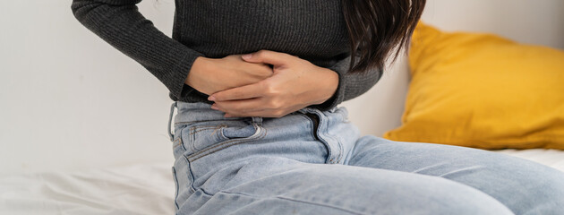 close up woman suffering stomach pain from food poisoning.
