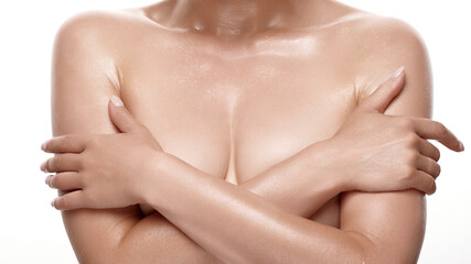 White caucasian sensual woman with beautiful natural breasts covers her naked bust with her hands...