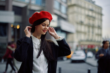 Woman smile with teeth tourist walks walks in the city on the background of office buildings, stylish fashionable clothes and make-up, spring walk, travel.