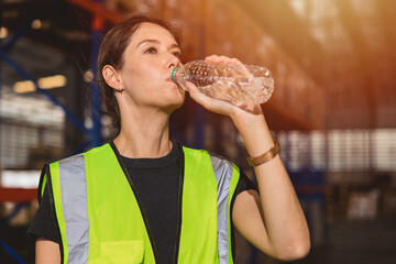 health care woman worker drinking clean water while working in hot place for refresh and personal...