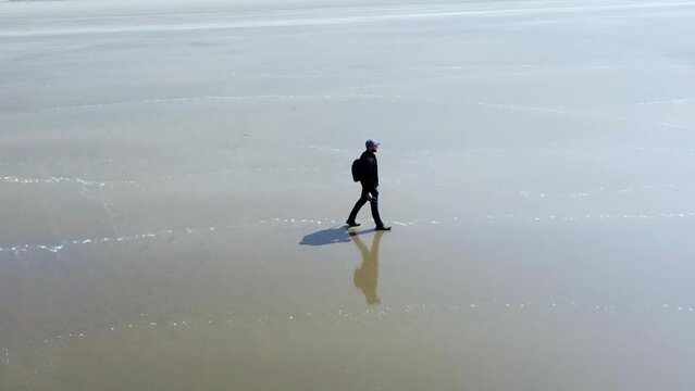 lone traveler walking on the sea beach of Cox's Bazar in Bangladesh