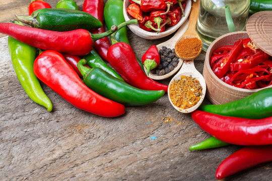 different seasonings for cooking, varieties of hot chilli pepper, ground pepper and spices, oil. for the text recipe