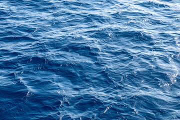 Very nice sea water background or backdrop with selective focus. Small waves of natural water surface texture.