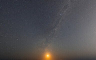 Moonlight and milky way galaxy in the night sky.
