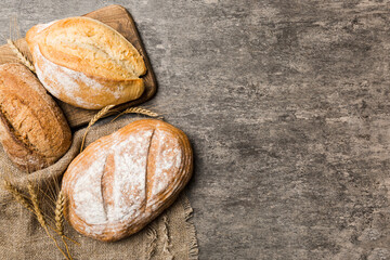 Homemade natural breads. Different kinds of fresh bread as background, top view with copy space