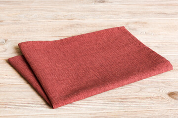 top view with red empty kitchen napkin isolated on table background. Folded cloth for mockup with copy space, Flat lay. Minimal style