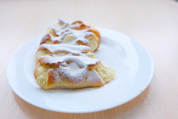 on rectangular white porcelain plate slowly sprinkle cottage cheese pies with powdered sugar as if it were snowing space for text advertising pastries cooking classes show food breakfast lunch dinner