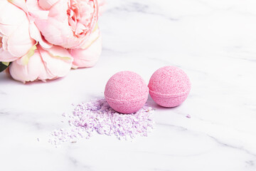 Pink bath bombs and flowers. Bath bombs and bath salt. Berry flavor