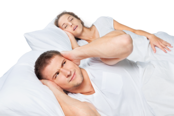Fed up man blocking his ears from noise of his wife snoring