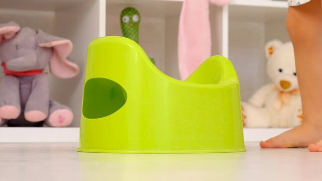 The child sits on the potty. Selective focus.