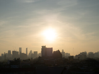 Fototapeta premium Sunrise over modern office buildings in Bangkok's business district City skyline view with sunlight in the morning