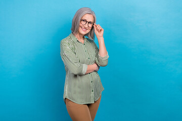 Photo of mature aged retired hr manager company business lady wear formal office dress code clothes touch glasses isolated on blue color background