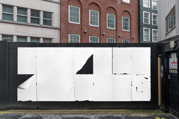 Blank posters mockup in the urban environment, on the facade, empty space to display your...
