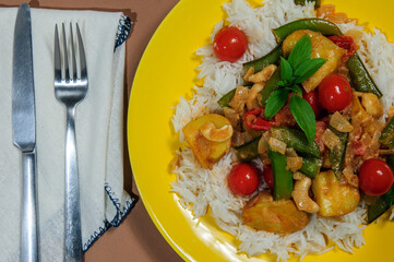 Baked chicken with vegetables on the plate.