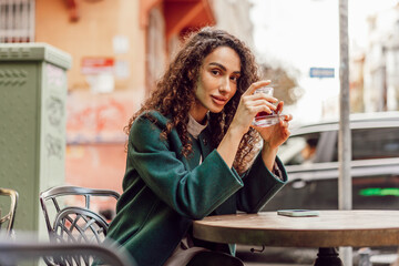 Woman tourist drinking traditional Turkish tea in outdoor cafe
