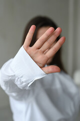 Young woman showing palm. Women show stop hands gesture with her hand close up