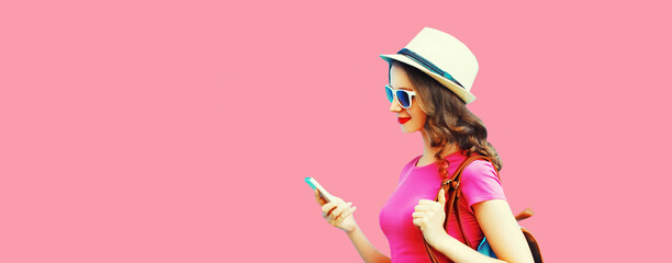 Portrait of happy smiling young woman tourist or student with smartphone wearing summer straw hat,...